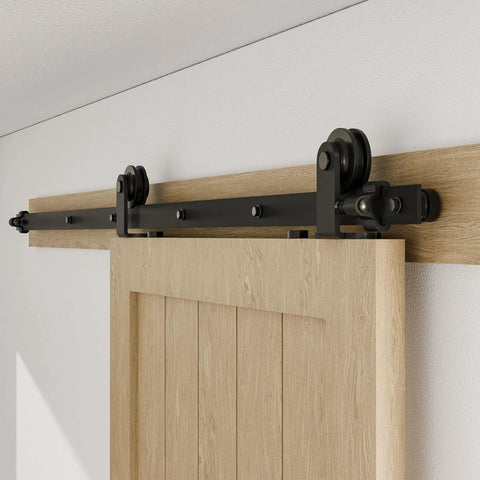 Beefy Heavy Duty Sliding Barn Door Hardware Kit With Top Mount Track In Black Finish Quiet Roller Hanger System For Single Door Supports Up To 220 Lb Hardware Only Door Not Included Includes Rubber Bumpers And Spring Door Stops 60 Inch Length installed on wooden door