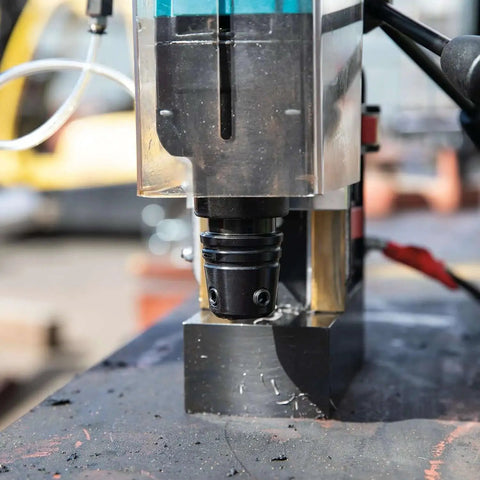 Close-up of Portable Magnetic Drill For Steel With One And Three Eighths Inch Capacity And Two Inch Thick Cutting in action.