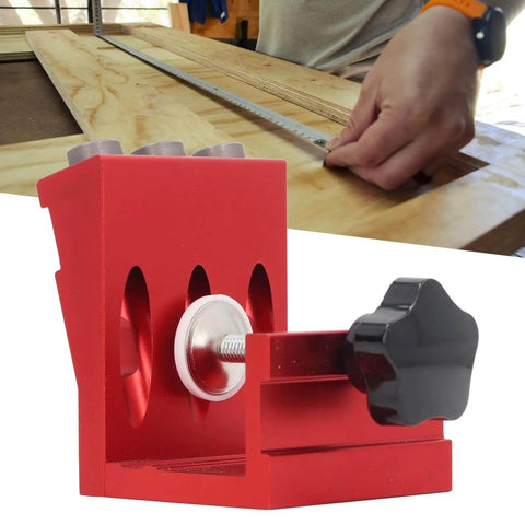 Pocket Hole Jig Set With Steel Bushings And Anodized Aluminum Body Delivers Precise 15 Degree Dowels For Woodworking, Cabinetry, And Furniture Assembly, Industrial Grade Durability, Reliable Accuracy, Ideal For Repeated Use In Shops shown in red with a woodworking setup in the background.