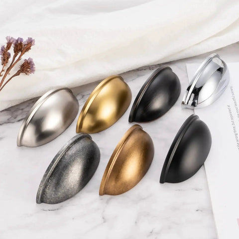 Assorted metal cabinet pulls including Brushed Gold Cabinet Pulls 3 Inch Hole Centers Bin Cup Handles Pack Of 10 shown on marble surface.