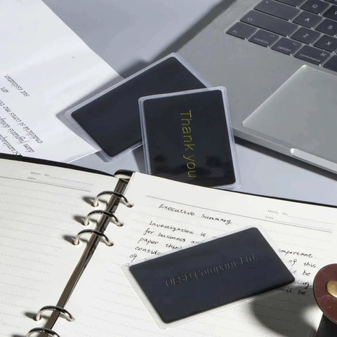 Pro Grade Thick Black Anodized Aluminum Business Cards 86x54mm 0.8mm Thick Set Of 15 With Frosted Protector Sleeves shown in office setup