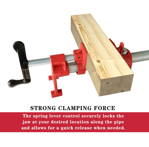 Red 3/4-inch H-style pipe clamp securing a wooden block; red jaws, steel rod, and black T-handle visible.