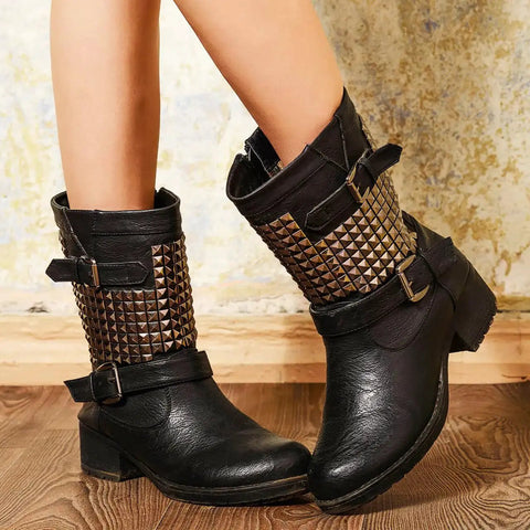 Black boots adorned with silver pyramid spike flatback studs for clothing belts leathercraft on wooden floor