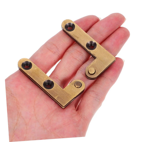 Hidden Door Hinge Set For Secret Bookcases And Concealed Doors, bronze finish shown on open palm, 2-pack.