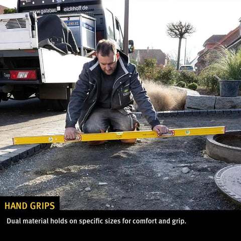 Man using Stabila Type 96M 72 Inch Magnetic Level for pro grade framing accuracy on outdoor construction site.