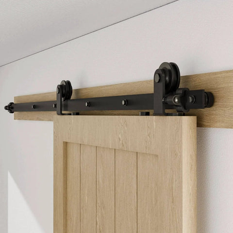 80" Sliding Barn Door Hardware Kit installed, showing black T shape hanger on top mount track for single wooden door.