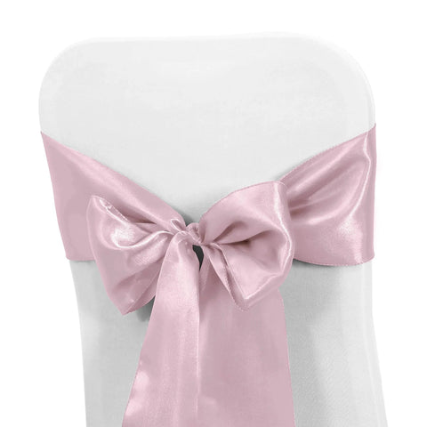 Pink satin chair sash bow tied on a white chair for wedding and banquet decor, 10 Piece Satin Chair Sashes Bows For Wedding Reception And Banquet Decor Universal Back Tie For Chairs Party And Hotel Events 7 Inches Wide By 108 Inches Long 100 Percent Polyester Satin.