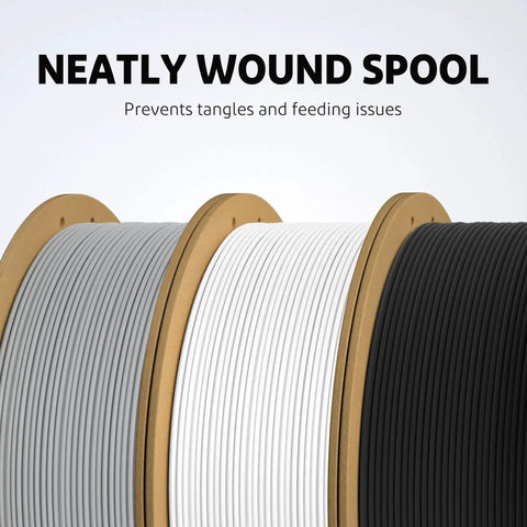 Close-up of neatly wound spools in gray, white, and black for FDM 3D printing, focus on filament organization.