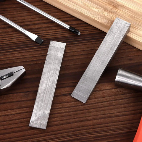 12 Pcs Flange Wedge Set In Stainless Steel One Half By Three Quarters By Four Inches Beveled Right Angle Wedges on wooden surface with tools