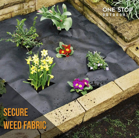 Raised garden bed with black weed barrier fabric and various flowering plants for garden installation.