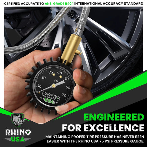 Rhino USA tire pressure gauge with braided hose and brass hardware; 2-inch glow dial reads 0–75 psi near a car wheel.