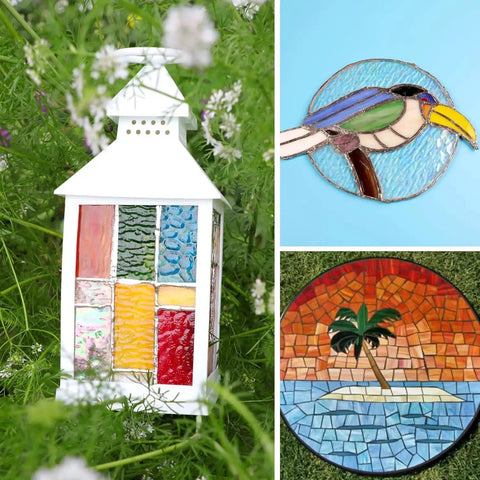 White lantern decorated with colorful stained glass panels, next to stained glass artworks of a bird and a tropical scene.