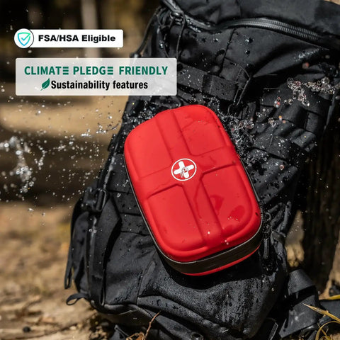 Compact Waterproof EVA First Aid Kit with 130 Essential Supplies attached to backpack in outdoor setting