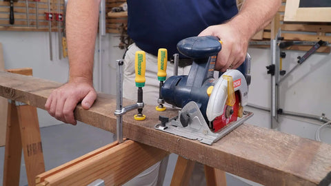 Woodworker using Matchfit Dovetail Clamps Four Pack Exclusive Bundle With Dovetail Router Bit One Quarter Inch Shank on wooden board