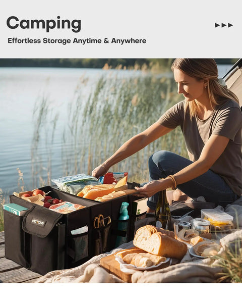 Foldable Car Trunk Organizer For SUVs And Sedans With Two Large Compartments And Six Mesh Pockets Keeps Groceries Tools And Gear Neat And Ready For Any Trip On The Go In Black displayed outdoors with camping supplies.