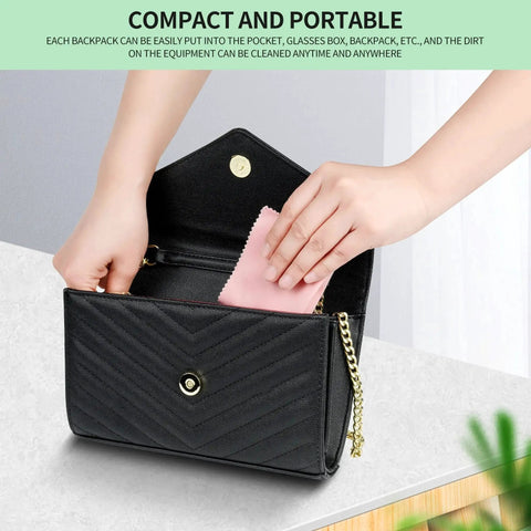 Person placing pink microfiber cloth from 18 Pack Multicolor Microfiber Cleaning Cloths 7x6 For Eyeglasses Lenses Phones into black purse.