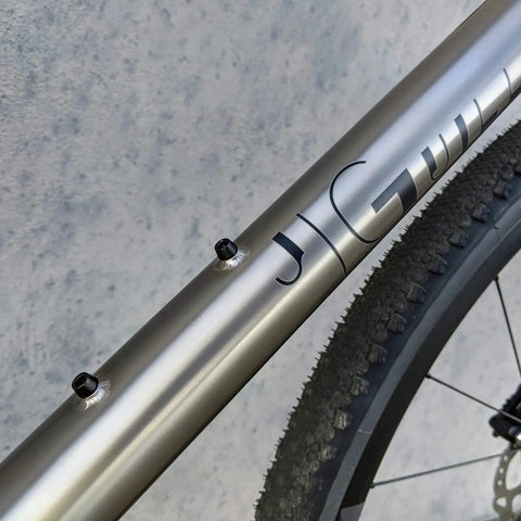 Ultra-strong and lightweight titanium bottle cage bolts deliver secure mounting and lasting durability for cyclists, featuring Grade 5 Ti6Al4V construction, compact head size, and precise M5x0.8 threads (4 pack), shown installed on a bike frame.