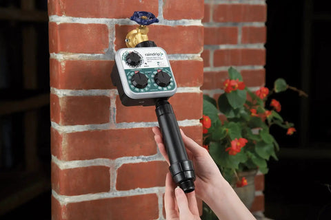 Automatic Drip Irrigation Kit With Timer For Ground Cover And Flower Beds installed on a brick wall