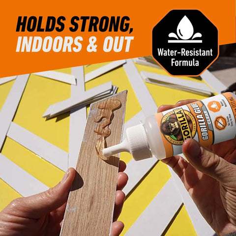 Applying Crystal Clear All Purpose Glue For Wood Stone Metal Ceramic Water Resistant on wooden surface, indoors with yellow design