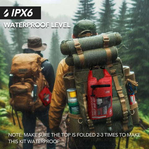 250 Piece IPX6 Waterproof First Aid Kit With Roll Top Reflective Boat Dry Bag in red attached to hiker's backpack in forest