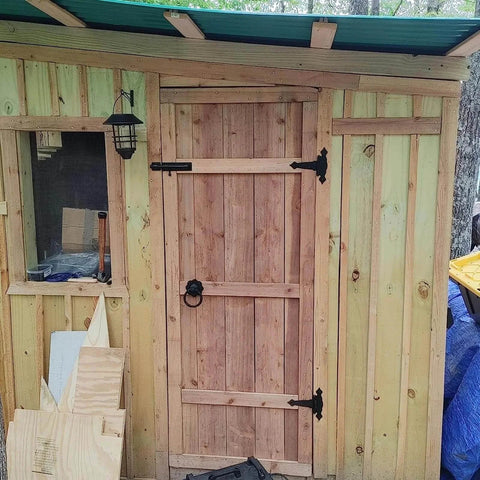 Wooden shed door with Six Pack 5 Inch T Shape Strap Hinges With Screws in classic black, outdoor-rated hardware installed.