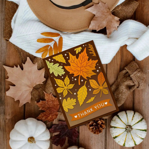 Autumn-themed card with leaf patterns and 'Thank You' message, surrounded by pumpkins and leaves.