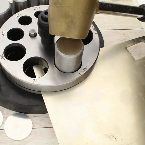 Pro Grade Heavy Duty Steel Circle Disc Cutter Set With Ten Punches and Die Cuts shown with sheet metal and punch tool