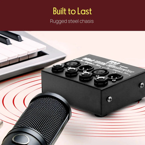 Compact Mini Hum Eliminator Box for Audio Gear with 1/4 Inch TRS and XLR Inputs, shown on desk with microphone