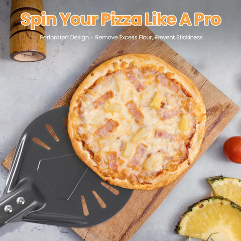 Perforated Pizza Turning Peel lifting a Hawaiian pizza on a wooden board, showing perforated aluminum design for crisp crust.