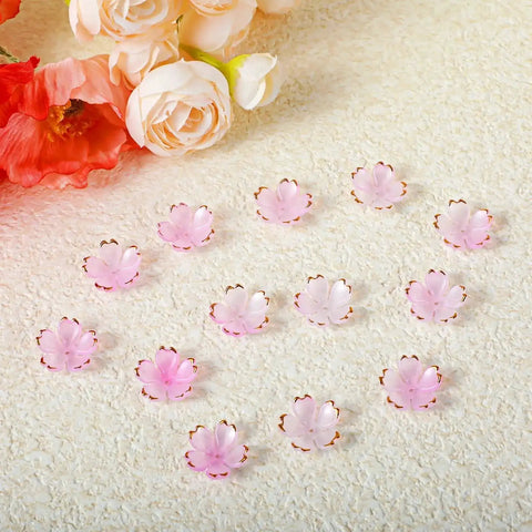 100 Pcs Cherry Blossom Acrylic Flower Beads For Jewelry Making And Bracelet Charms, pink gradient with gold edge, arranged on surface