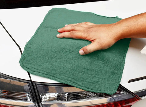 Person using Heavy Duty Shop Towels 50 Pack Green Terry Cloth Rags For Car Detailing And Home Cleaning Highly Absorbent Reusable Washable Towels For Oil Grease Spills Glass Polishing And Surfaces on car exterior
