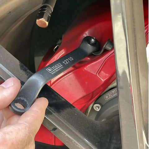 3 Piece 11mm Offset Brake Bleeder Wrench Set For Audi BMW VW Caliper Mounted Electromechanical Parking Brake Compatible No Wheel Removal Easy To Use Great For DIYers, shown being used on a red vehicle brake caliper