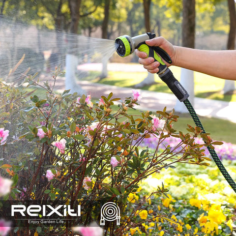 Relxitl garden hose with green and black 10-function sprayer watering pink azalea bushes in a garden