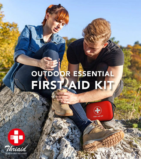 Man using Travel Ready 100-Piece First Aid Kit in a water-resistant red case outdoors while assisting injured woman on hike.