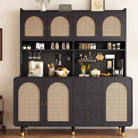 Contemporary kitchen storage cupboard with a dark finish and rattan doors, accessorized with various utensils and decor items.