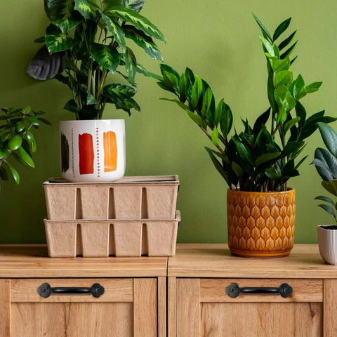 Zinc Alloy Modern Black Pull Handles For Wardrobe Cupboard And Drawer Hardware installed on wooden cupboard with decorative plants above.