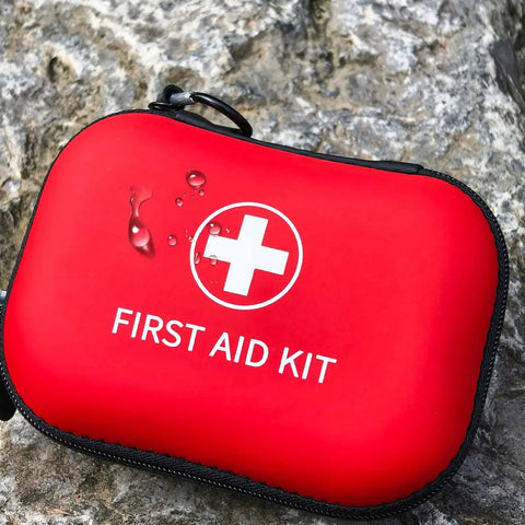 Red water-resistant case of On The Go 138 Piece Mini First Aid Kit Prelady Travel Size For Car Hiking And Home TSA Approved Compact Med Kit
