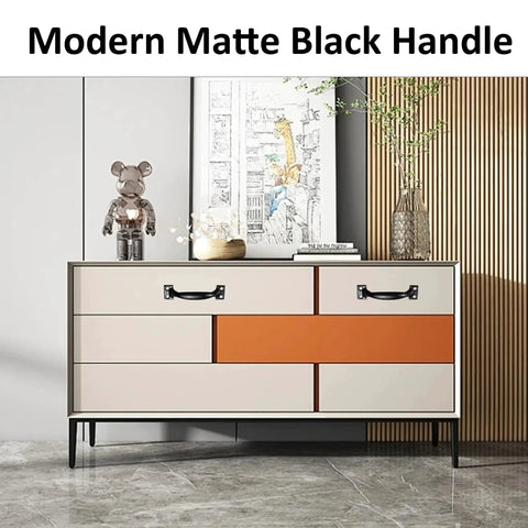 Modern matte black handle installed on a beige and orange cabinet, showcasing the 12 Pack 4 Inch Vintage Barn Door Pulls In Black Metal Screw In Handles For Cabinets And Drawers Heavy Duty Rustic Gate Knobs For Kitchen Furniture And Outdoor Use.