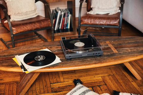 Fully Automatic Bluetooth Belt Drive Turntable With AptX on wooden table in living room with vinyl records, Gun Metal Black finish
