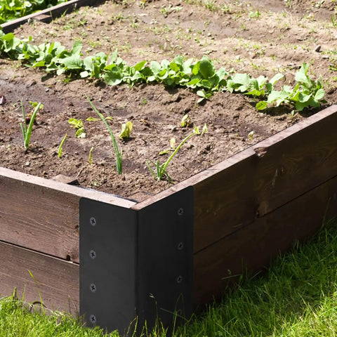 Four Pack Raised Garden Bed Corner Brackets 3 By 3 By 6 Inch Metal L Shaped Corners With Screws installed on wood frame in garden