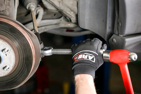 Ball Joint Separator Pickle Fork 15/16 Inch Tapered Fork with Knurled Handle being used to separate car ball joint