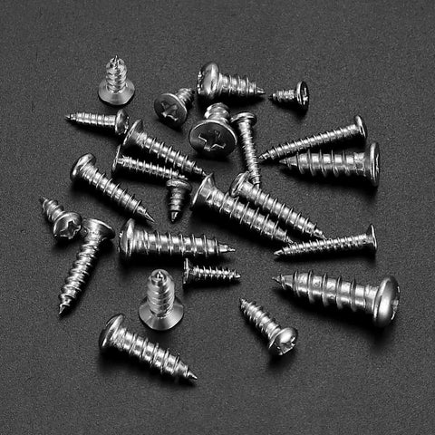 990 Pcs Self Tapping Screws Assortment Kit In Stainless Steel, flat and round head screws scattered on black background
