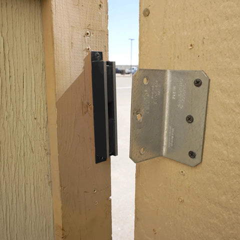 AM3 RM100C Magnet Catch Industrial Type with mounting holes, black finish installed on wooden door for heavy-duty enclosures