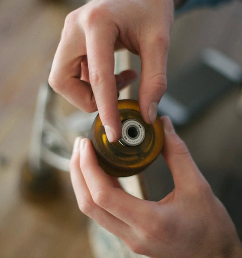 Person holding a rollerblade wheel with Premium Ceramic Bearings Set Of 8 For Skateboards Longboards Inline Skates And Rollerblades.