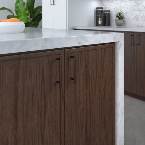 Brushed Oil Rubbed Bronze Cabinet Handle Four And A Quarter Inch Center To Center Steel Drawer Pull installed on dark wood cabinet in kitchen