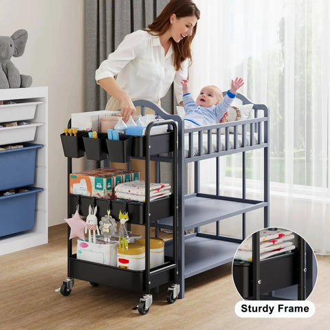 Three Tier Metal Rolling Cart On Wheels In Black, used as nursery organizer, beside crib, holding baby items and essentials.