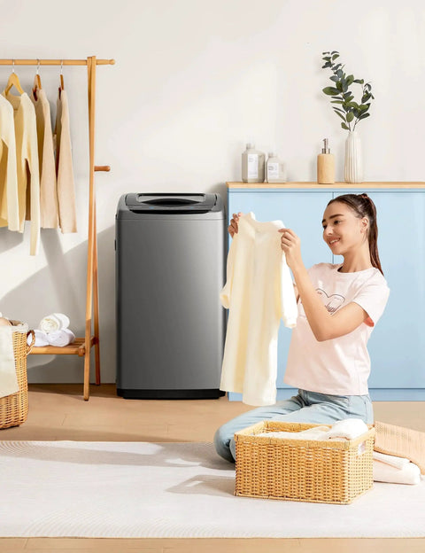 Woman with Compact Portable Washer 0.9 Cu Ft With LED Display And 5 Wash Cycles in a modern laundry room