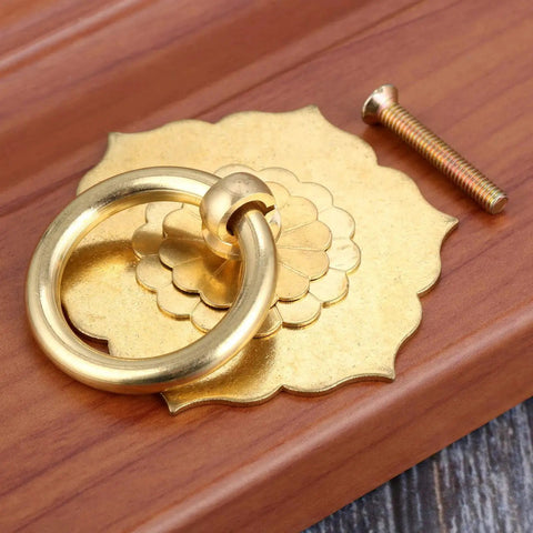 Antique Brass Ring Pulls For Cabinets And Doors Hexagon Flower Design on wood surface with installation screw