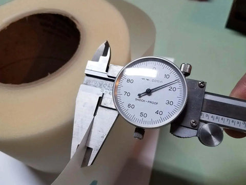 Caliper measuring 4 Inch By Point Zero One Five Inch By 100 Foot Urethane Die Protection Film For Press Brake Protects Stainless Steel And Painted Parts