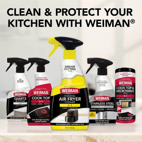 Assorted Weiman cleaning products, including Foaming Air Fryer Cleaner Kit with Non Abrasive Sponge for Ceramic Baskets, on a countertop